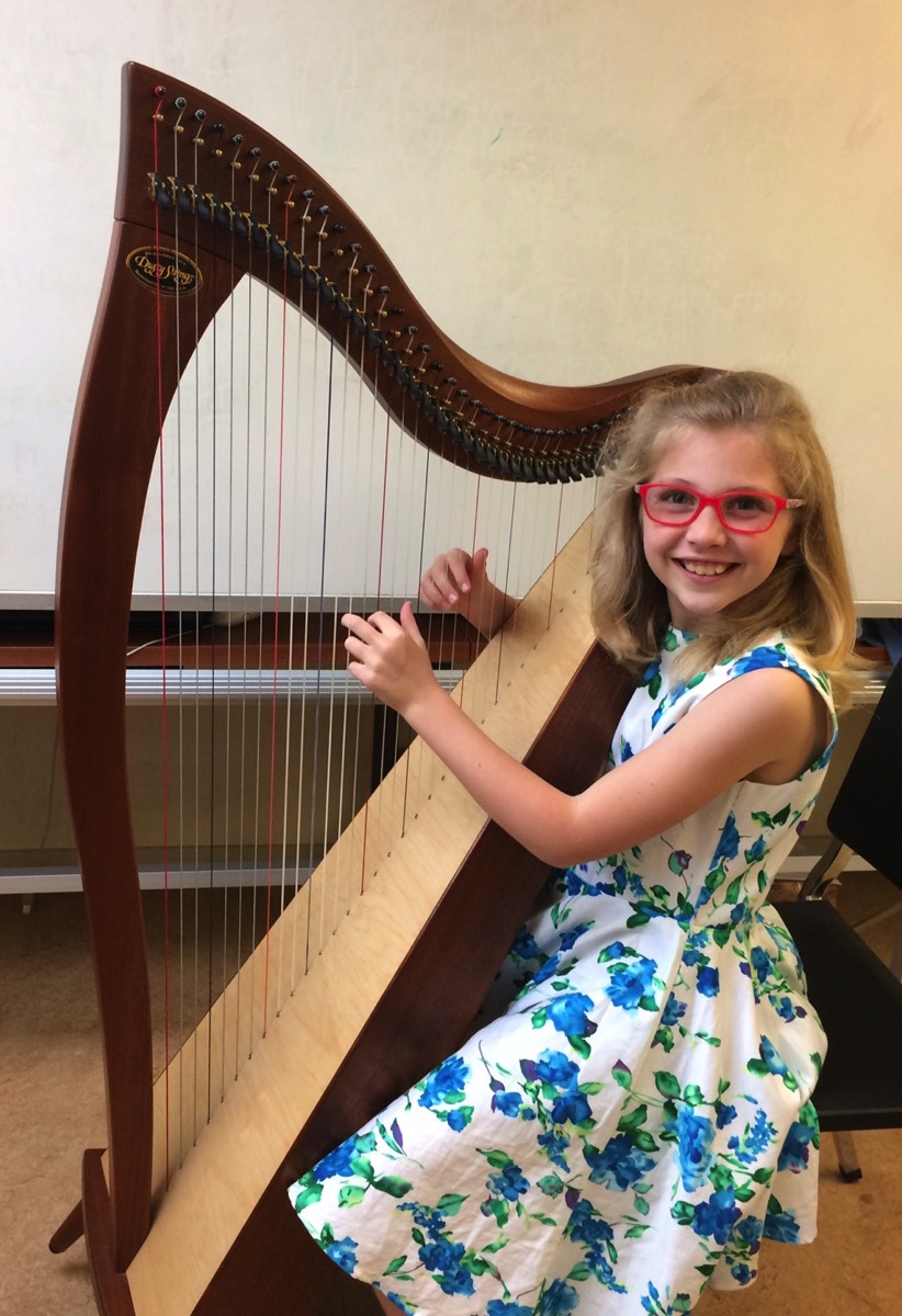 Young girl playing harp